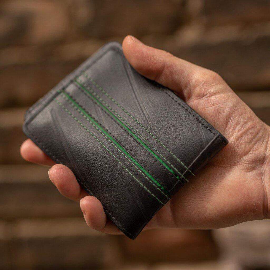 Bifold wallet made from recycled inner tubes - in hand
