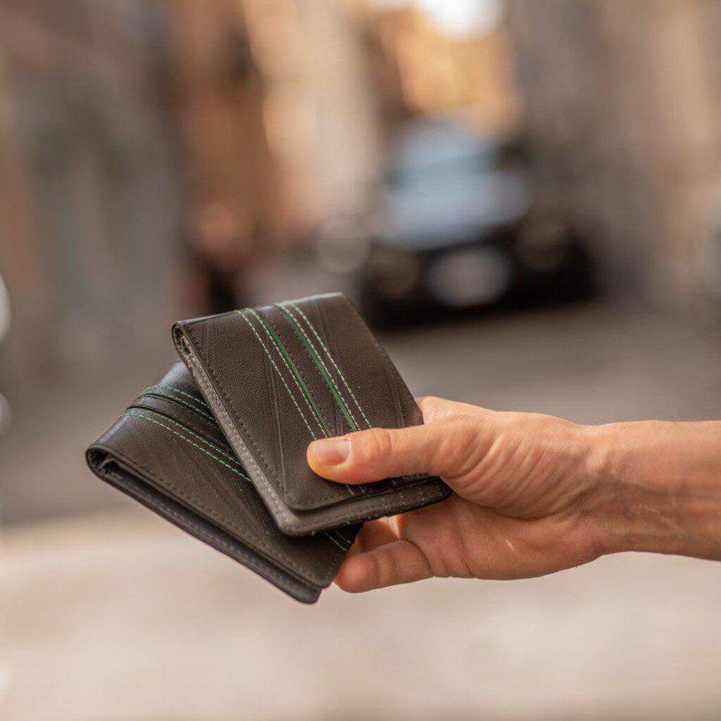 Bifold wallet made from recycled inner tubes - two ethical wallets being held