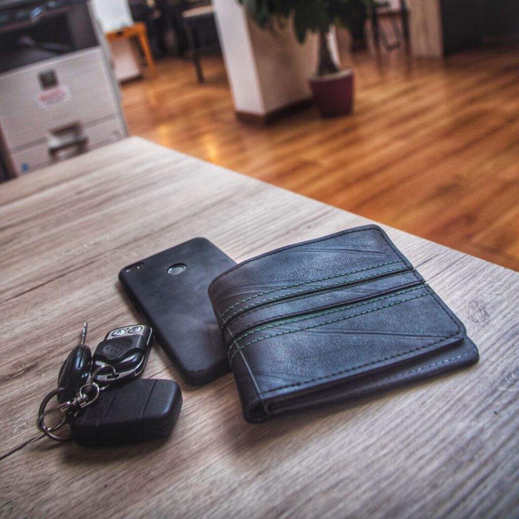 Bifold wallet made from recycled inner tubes - on coffee table