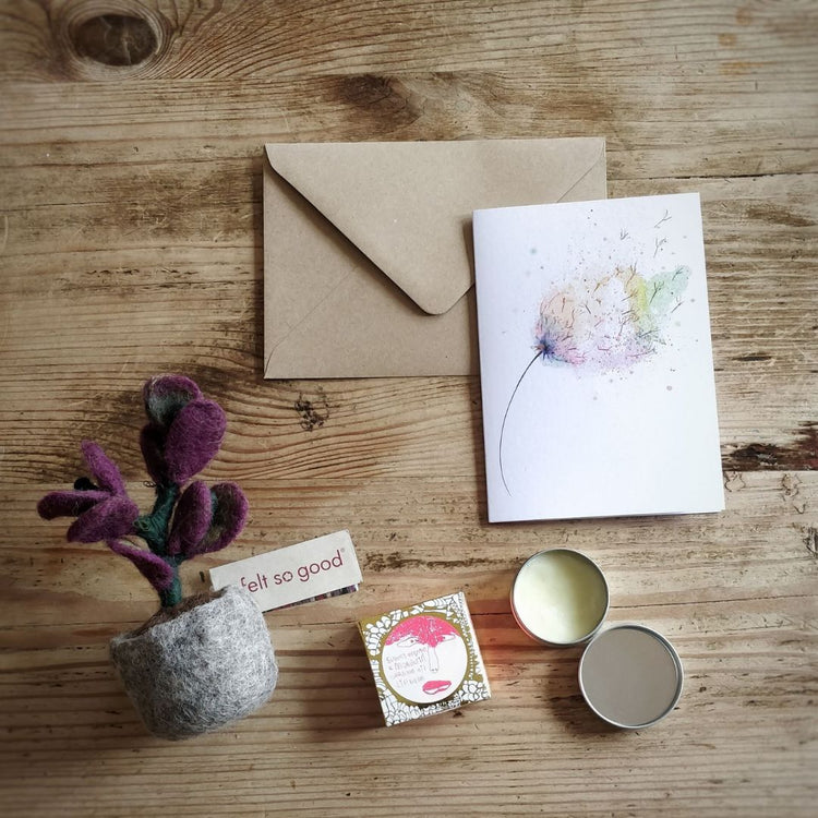 Corporate gifts collection image - showing recycled card, organic vegan lip balm and Fair Trade felt plant