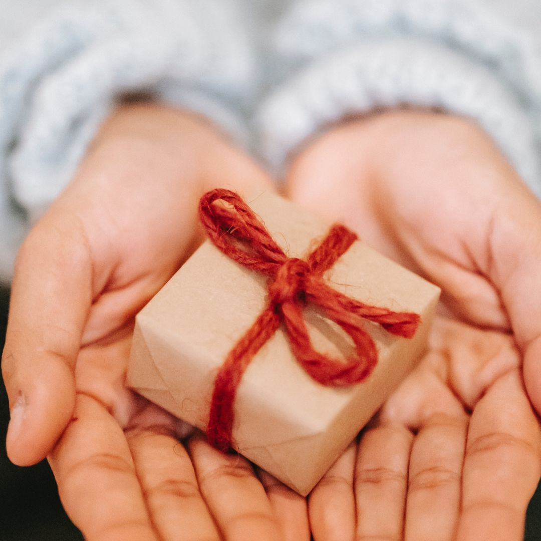 The Ultimate Guide to Eco Friendly Gifts 2023 - hands holding small gift