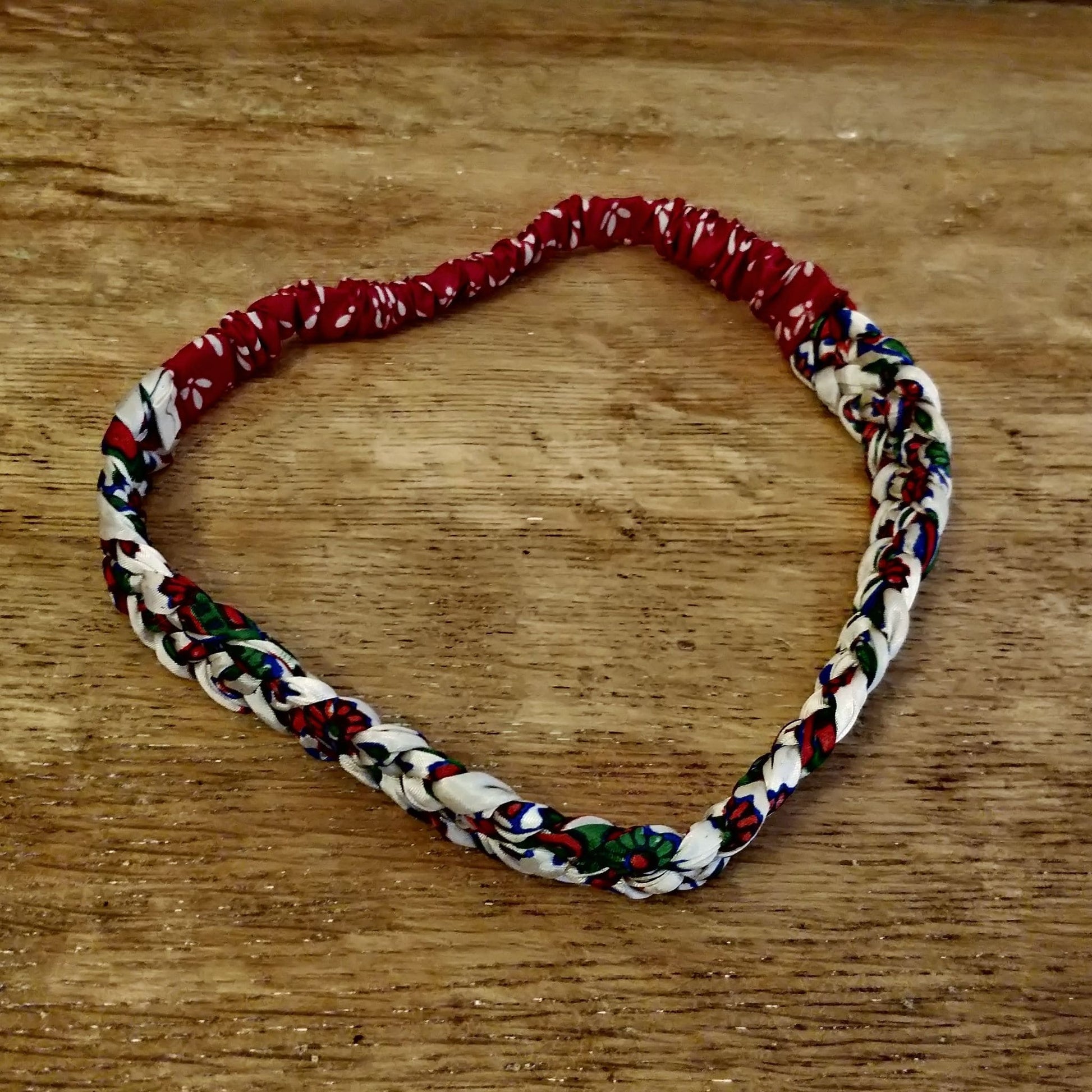 Braided Sari Headband Empowering Women in India - red hair band on wooden table