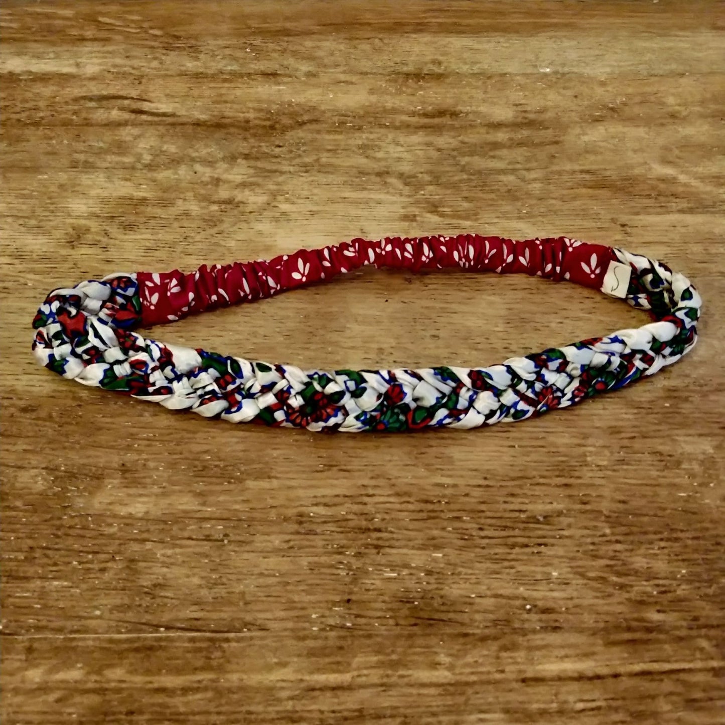 Braided Sari Headband Empowering Women in India - red hair accessory on wooden table