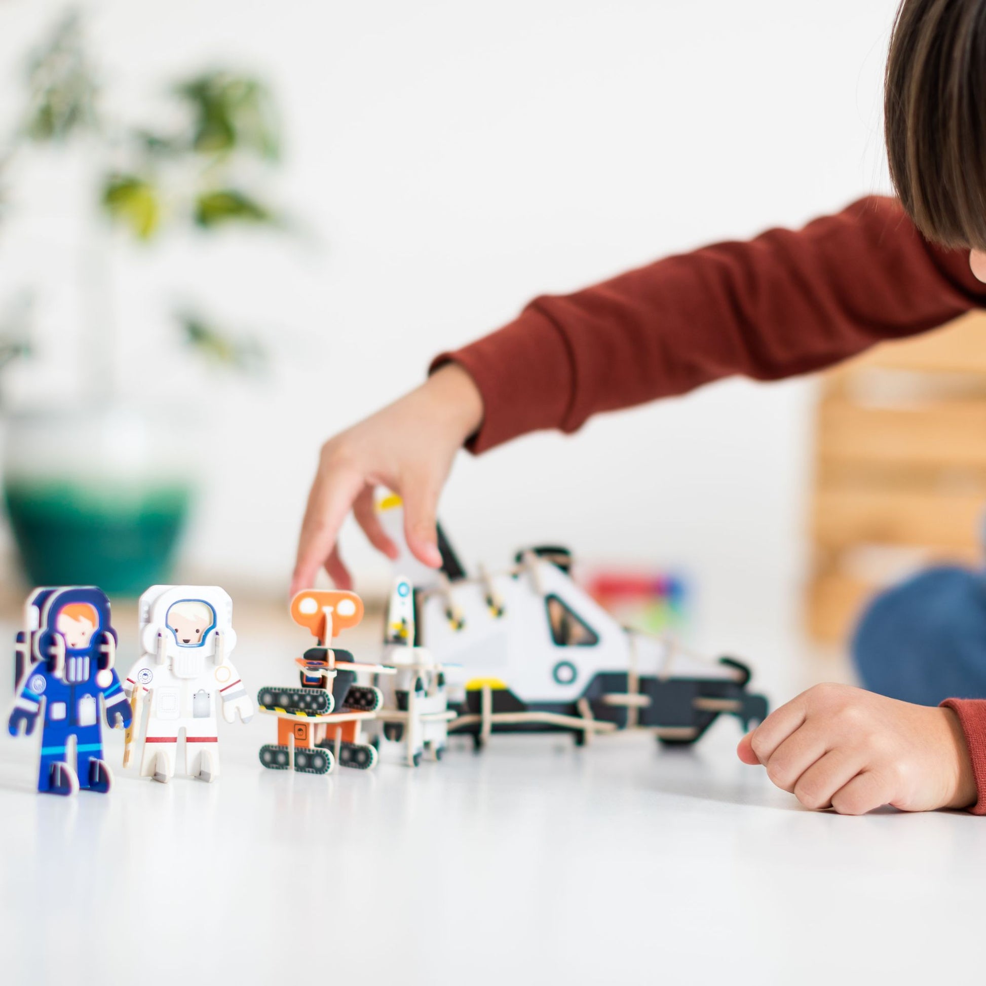 Build and play space toy - child playing - robots astronauts