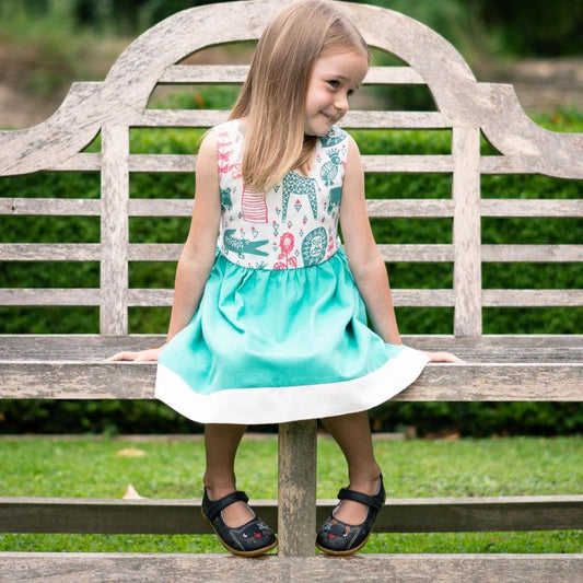 Children's Safari Print Dress Handmade and Fair Trade - child on bench