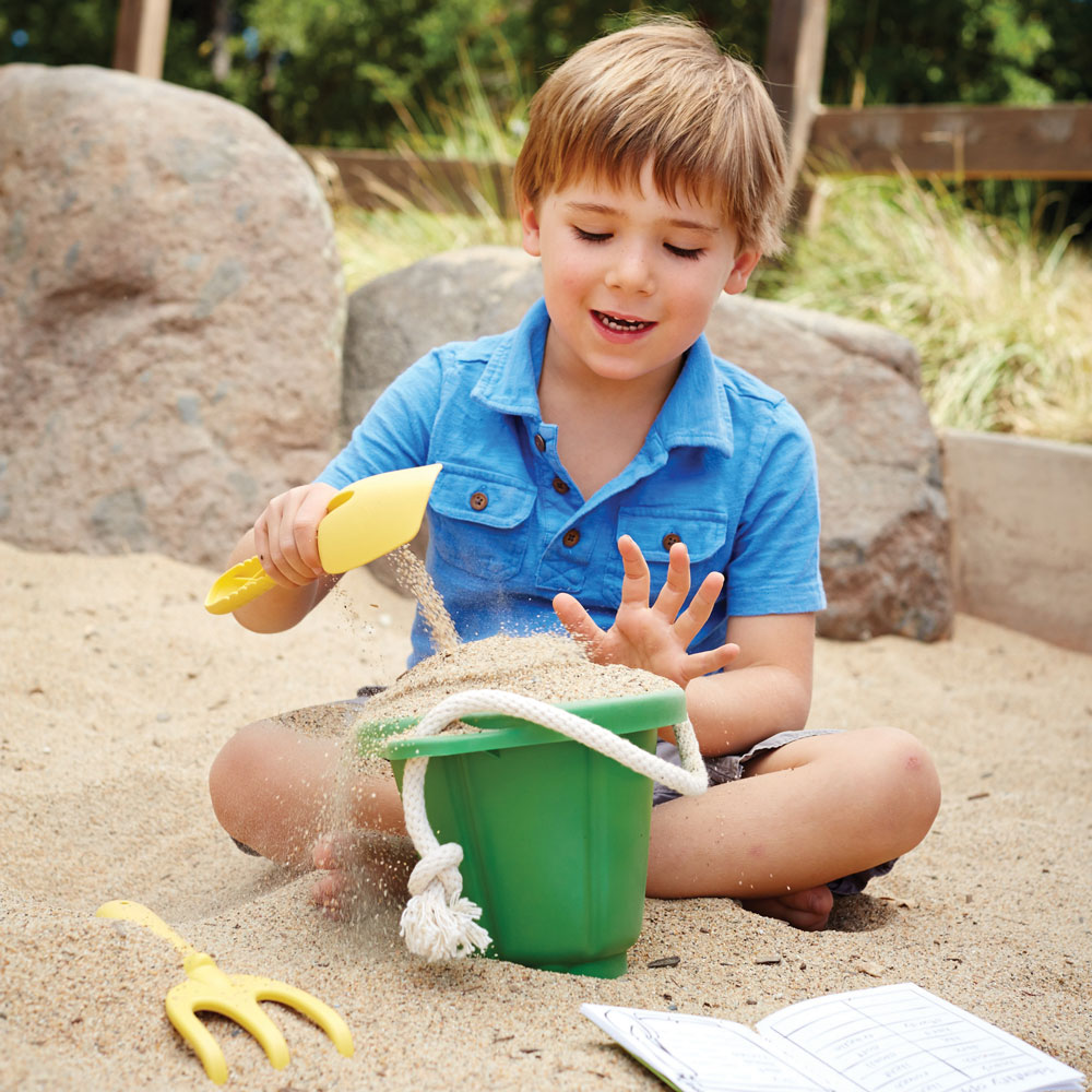 Green Toys Beach Bucket and Spade Set - child playing with eco friendly bucket and spade