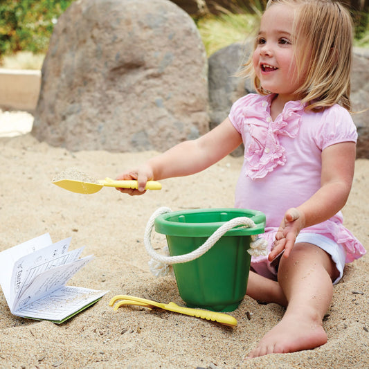 Green Toys Beach Bucket and Spade Set child digging using best bucket and spade sets