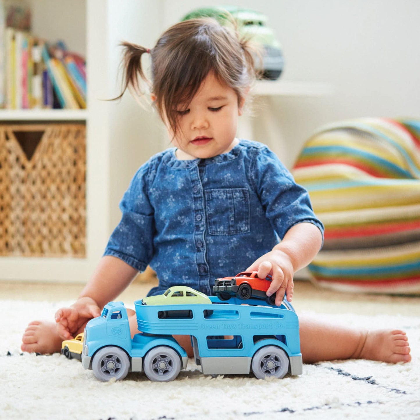Girl playing with Green Toys Car Carrier with toy cars - eco toy vehicles