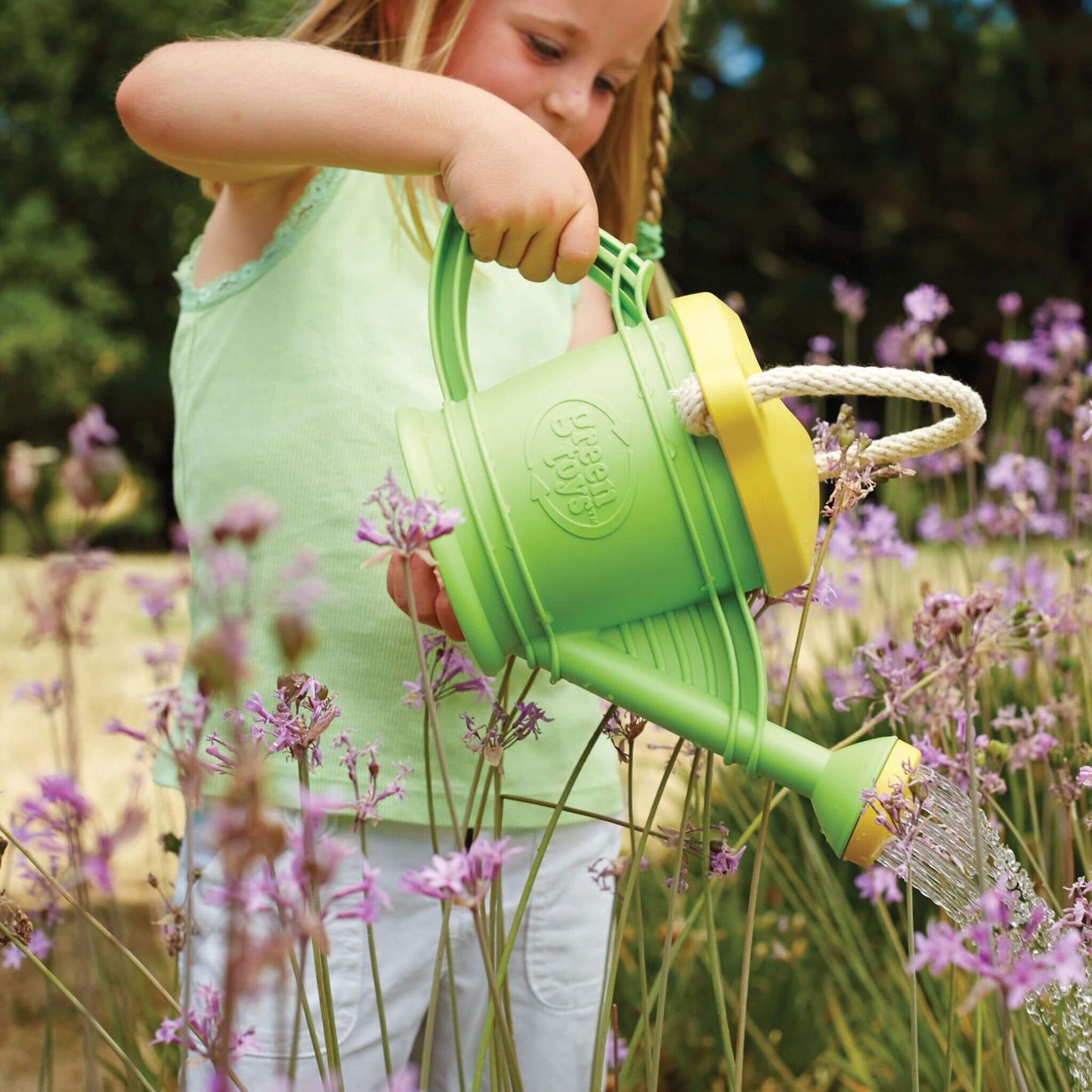 Eco friendly outdoor toys - child waters garden using children's gardening toys