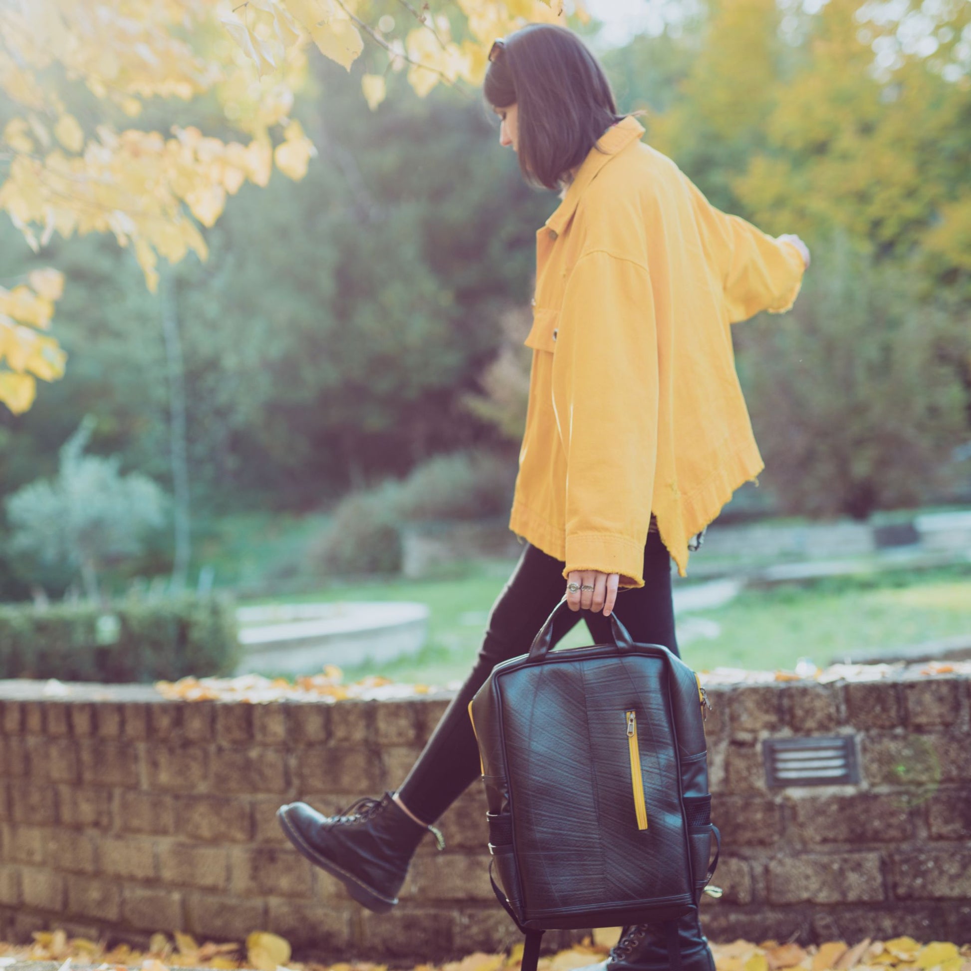 Hackney Backpack made from Recycled Materials - holding sustainable backpack in hand