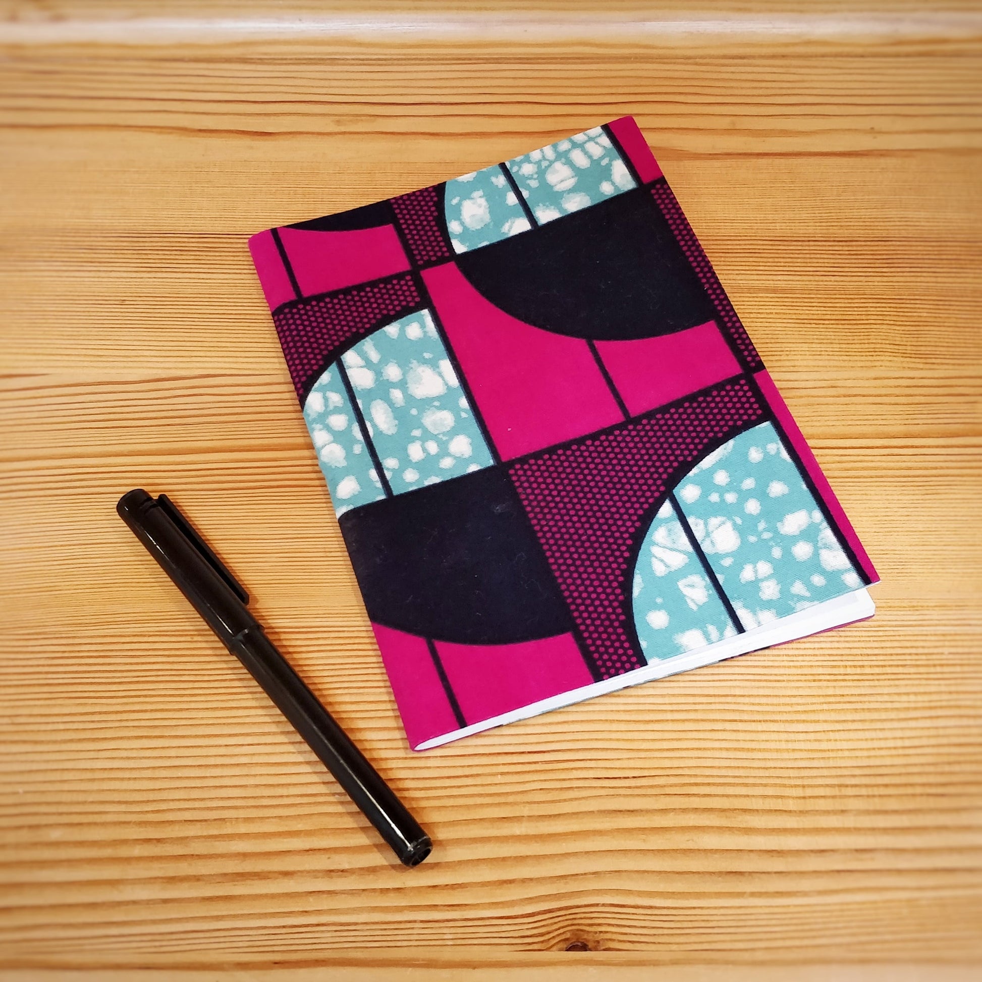 Handmade and Fair Trade Fabric-Bound Notebook - Pink on table