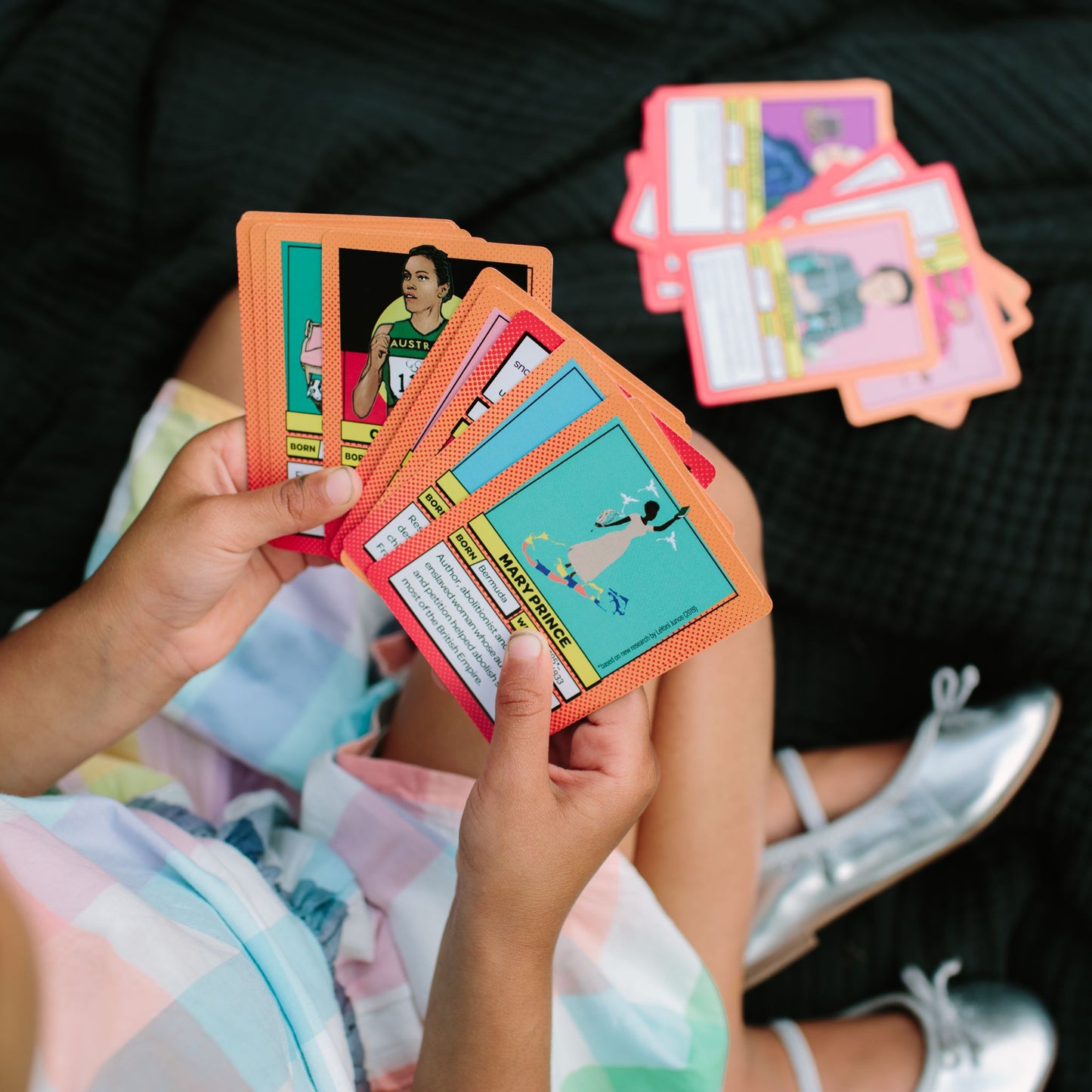 Super Sapiens  A 3-in-1 Game to Help Change the World - Ava playing with cards